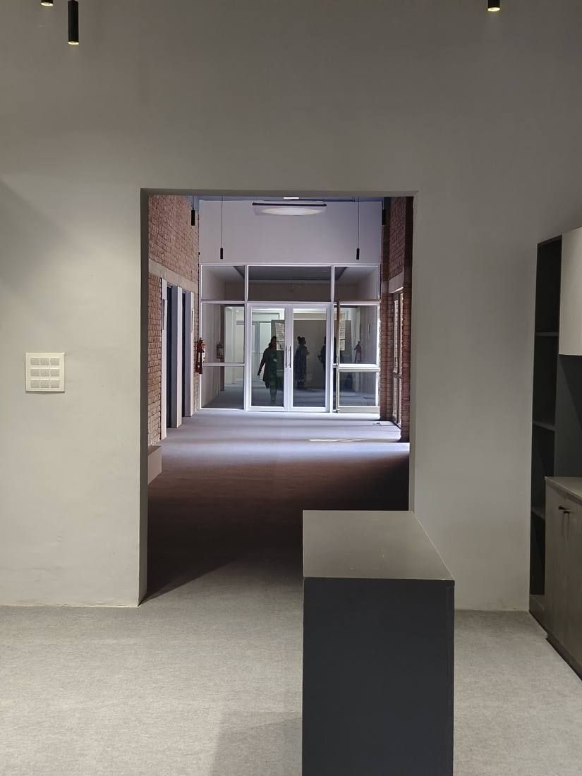 View through a doorway along the office corridor at IILM University
