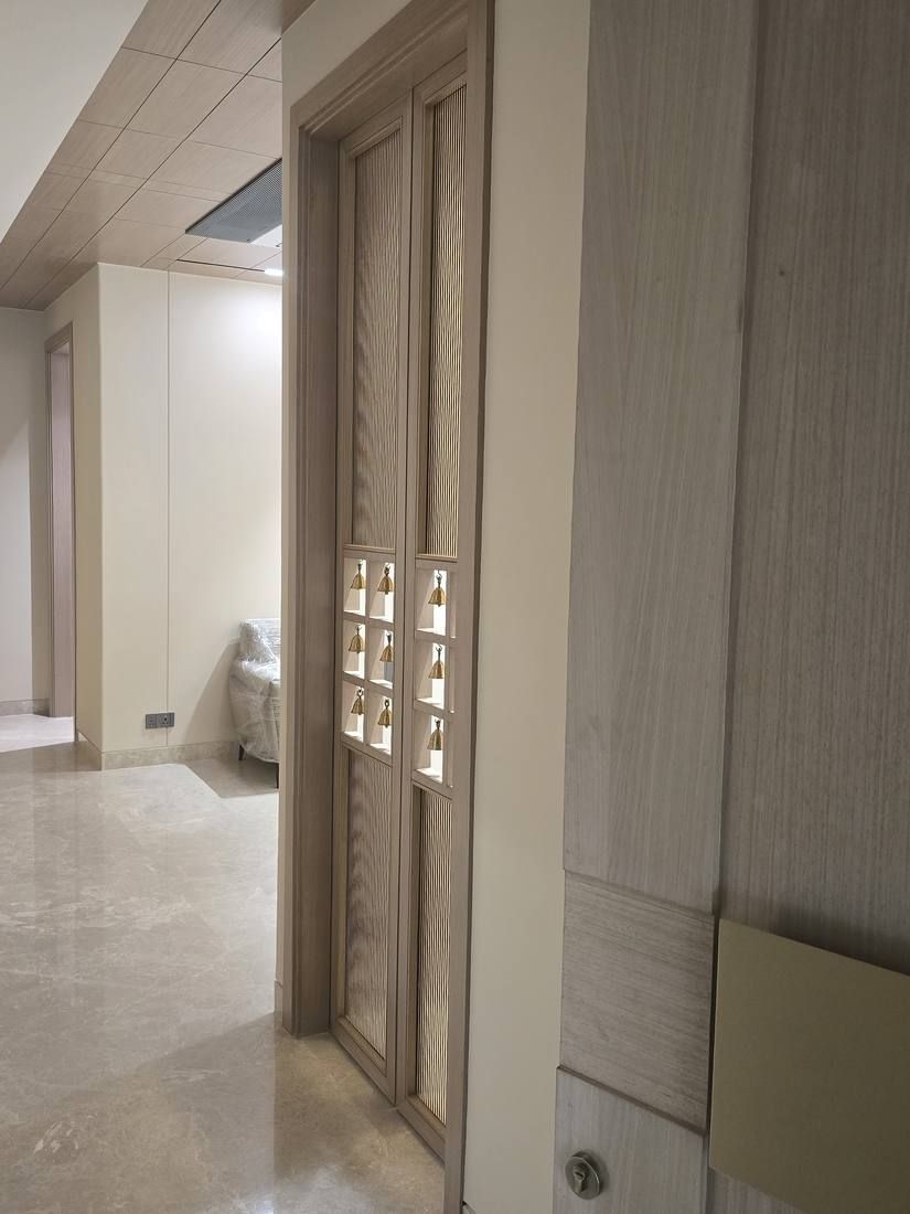 Veneer door and panelling in a marble-floored room