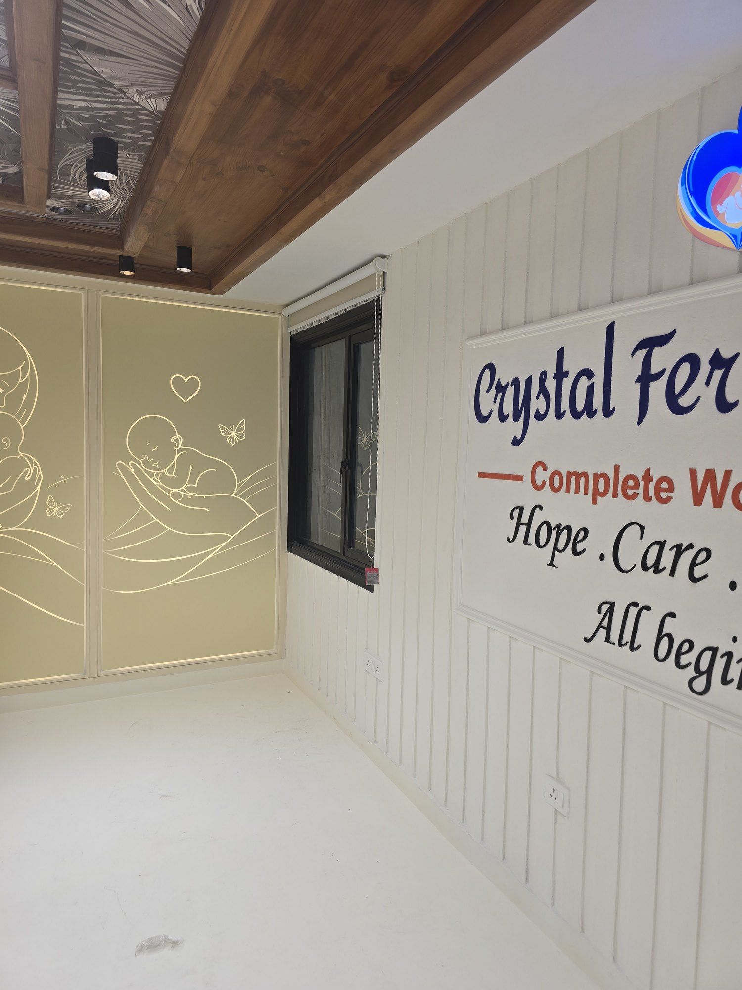 Illustrated wall panels and clinic signage reading Hope, Care, Happiness at Crystal IVF
