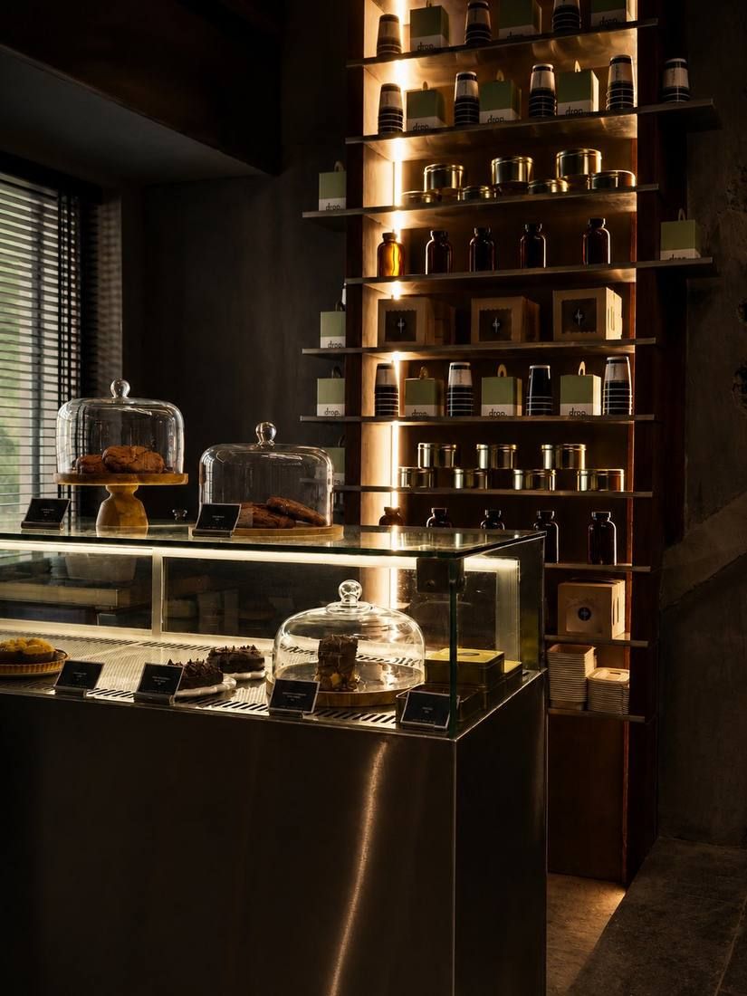 Backlit display shelving and a glass cake counter at The Drop