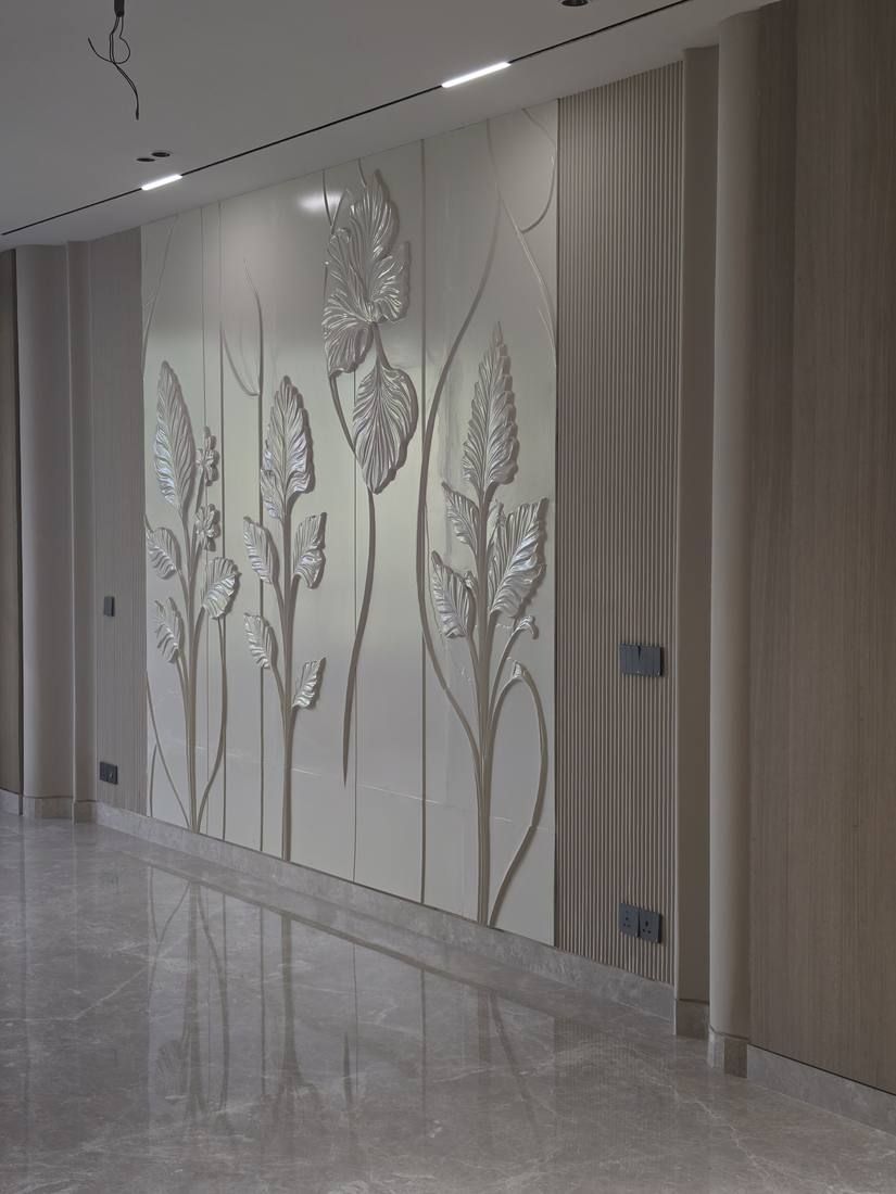 Close view of the botanical relief wall with wall lights