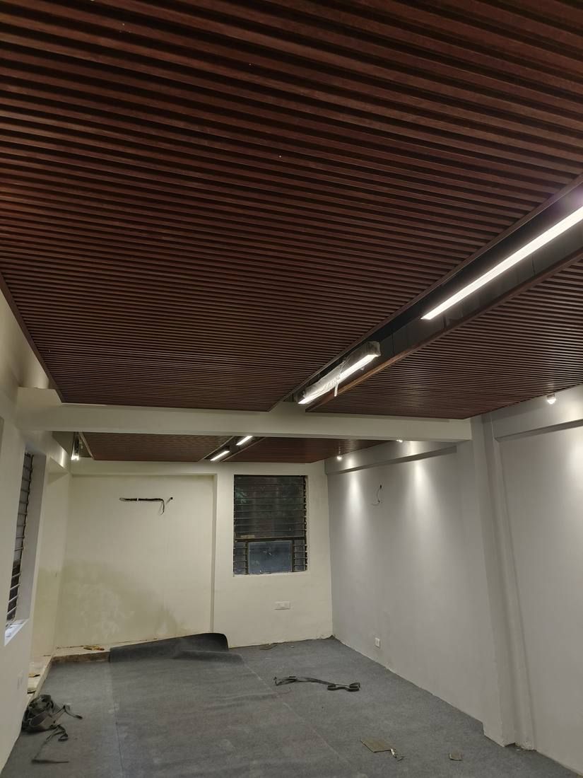 Wood batten ceiling with linear lights over an office room